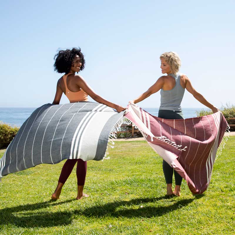 Compact Turkish towel rolled up in a beach tote bag for travel